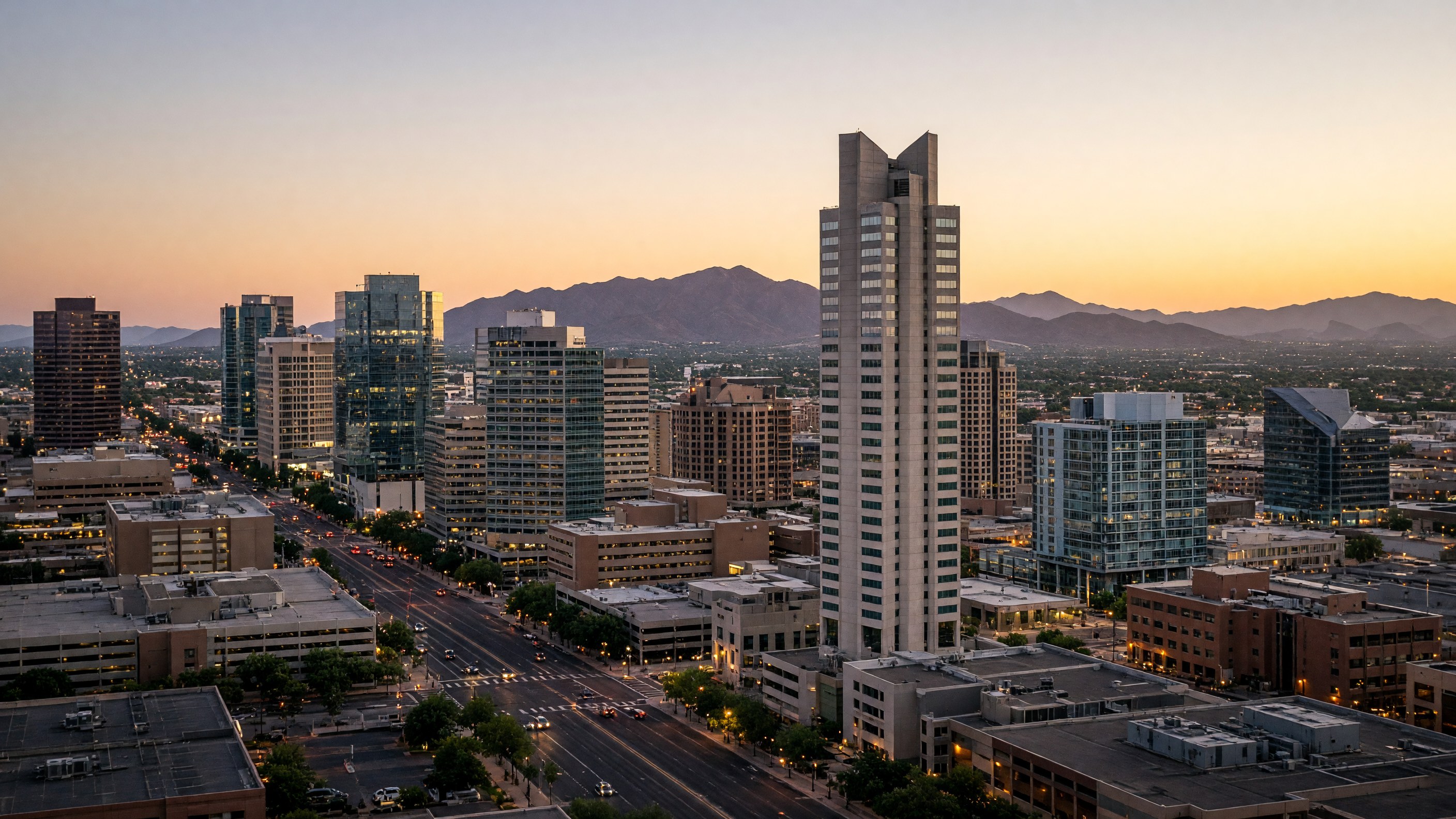 Phoenix skyline at dusk, with Chase Tower, downtown Phoenix high-rises, South Mountain in the distance